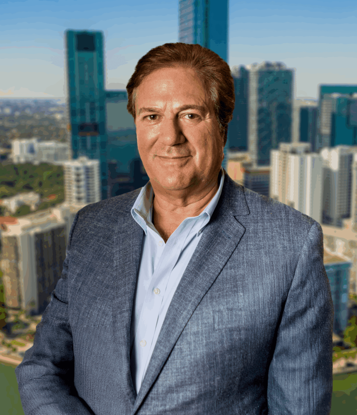 A headshot of Robert Regalado layered over an image of the Miami skyline.